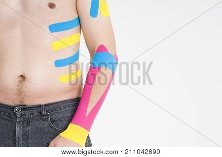 Kinesio tape kinesiology taping on man hand gray background