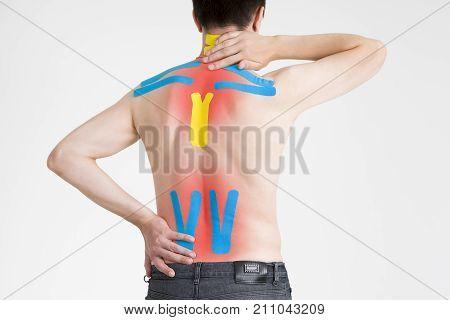 Kinesio tape kinesiology taping on man back gray background
