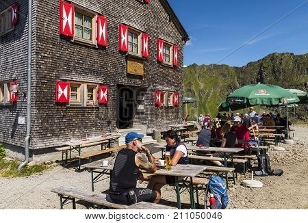 Tschaguns Austria - July 17 2017: People and hikers at the Wormser Hütte in the Montafon Alps on a summers day at the terrace of the restaurant Austria.