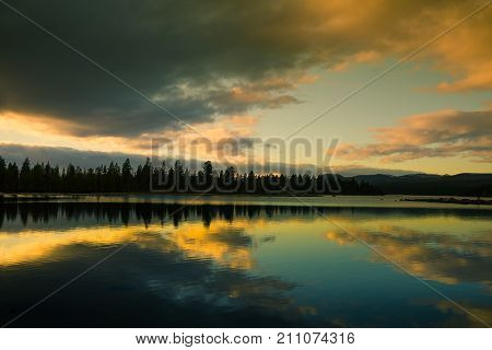 A beautiful lake landscape in Femundsmarka National Park in Norway. Lake with a distant mountains in background. Beautiful autumn scenery with vivid colors.