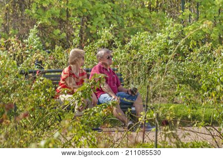 MONTEVIDEO, URUGUAY, MARCH - 2016 - Adult couple sitting at park at prado neighborhhod in Montevideo city Uruguay