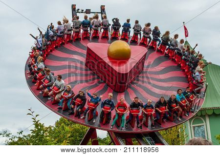 Gothenburg sweden - July 1. 2013: Young people having fun in Hanghai which is a swinging and spinning attraction in the Liseberg amusement park