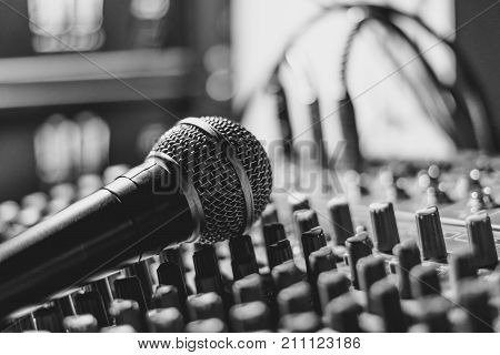 the microphone rests on an audio mixer
