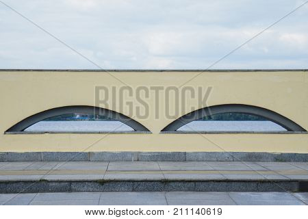 Window arch high in the wall. blue sky