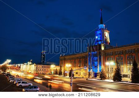 Yekaterinburg Russia. Illuminated administration building in Yekaterinburg Russia at night. Dark blue sky and car traffic lights