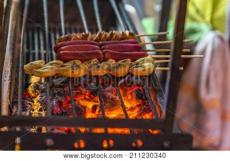 Grilled Squid's Egg And Hot Dog On Street Food Thailand