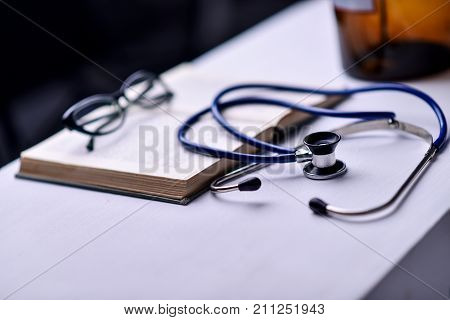 Stethoscope and book on Desk in a medical office