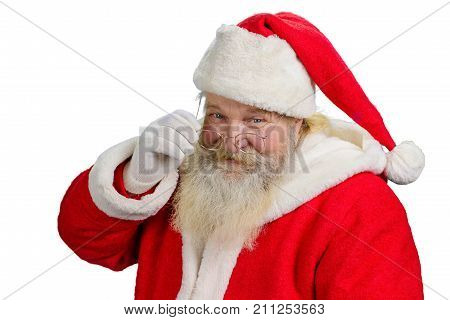 Santa Claus removing his glasses. Portrait of cheerful Santa Claus isolated on white background close up. Santa Clause tuching his eye glasses.