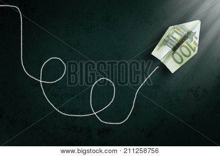 hundred euro paper plane going towards a light beam abstract money concept