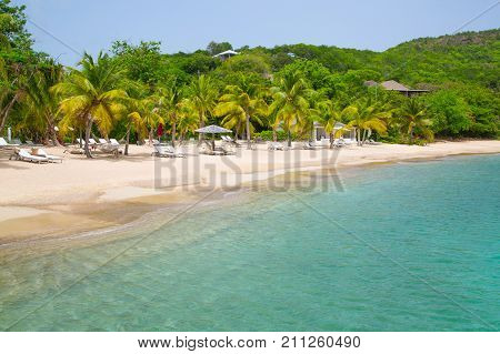 Antigua, Caribbean islands - May 20, 2017: English Harbour view with Galeon beach, sun beds and umbrellas