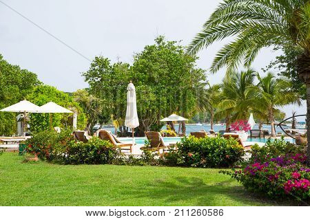 Antigua, Caribbean islands - May 20, 2017: English Harbour, Galeon beach hotel and swimming pool, sun beds and umbrellas