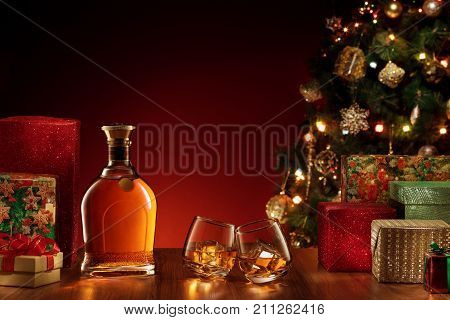 close up view  of  bottle and two glasses with whiskey on color back.