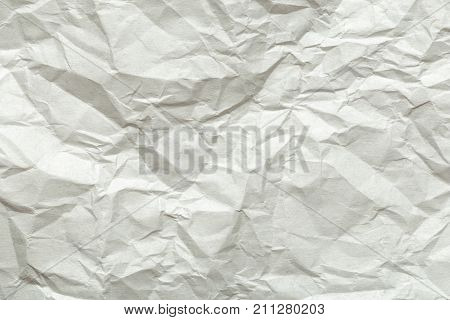 Crumpled white paper background texture for usage in design
