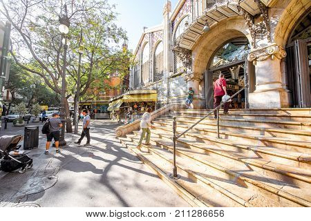 VALENCIA, SPAIN - August 19, 2017: Entrance to the central food market located in across from the Llotja de la Seda and the church of the Juanes in Valencia city