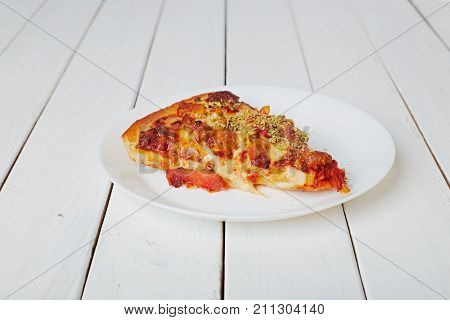 Top view of Italian rustic one slice pizza on white wooden table background concept flat lay food