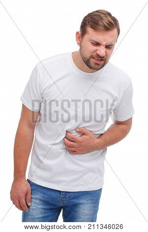 A man with a beard and a white T-shirt holding his stomach and twisted his face. A demonstration of pain. On a white background.