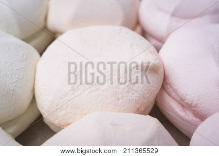 Sweet marshmallow closeup on a light wooden background