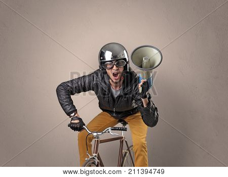 Nerd young foolish biker on a bike with oldschool outfit