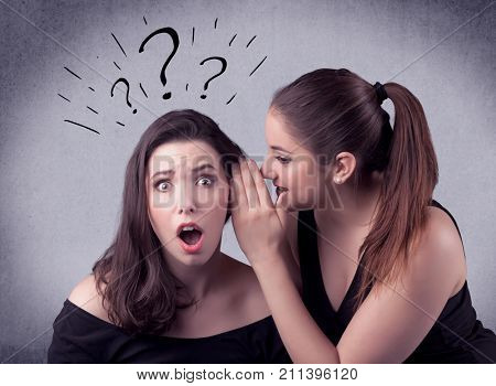 A teenager girl looking confused with drawn question marks above the head, while a girlfriend whispers something in her ear concept.