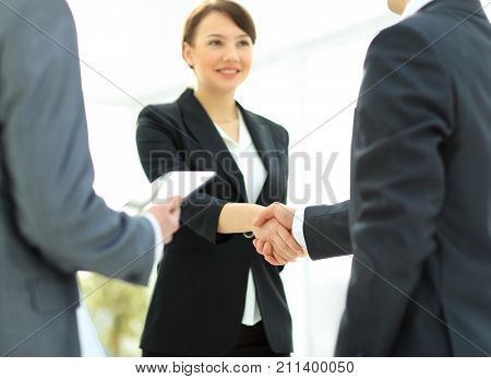 Businesswoman shaking hands with a businssman during a meeting