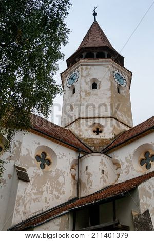 Fragment of the church and the watchtower with the clock of the Fortified Church Prejmer in Prejmer city in Romania