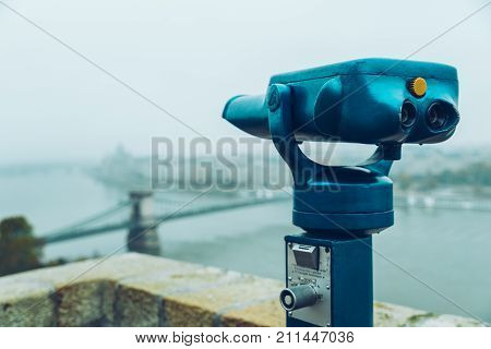 Binocular against observation deck view of old european city