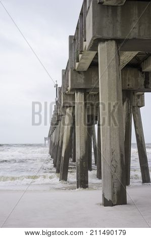 Huge concrete beach fishing pier in Pensacola Florida as tropical storm comes ashore.