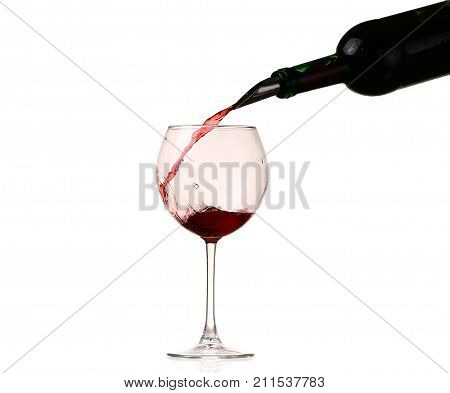 red wine glass on a white background, splash, pouring. Wine collection - Splashing red wine in a glass. Isolated on white background and pourer