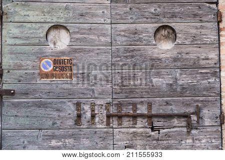 Appignano (Ancona Marches Italy) buildings of the historic village: old wooden door with rusty sliding lock