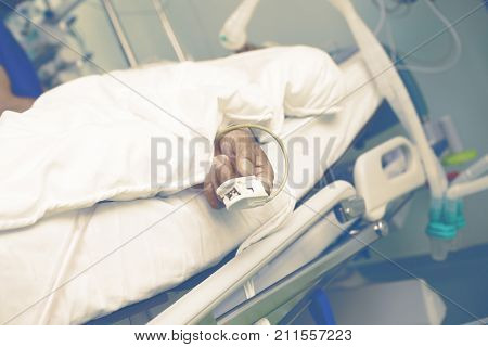 Life support of an old man in the ICU.