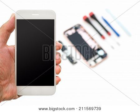Close-up of new smartphone screen in technician hand on blurred smartphone component background with copy space