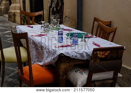 Beautifully served table from tavern on narrow street of Siracuse Sicily Italy