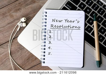 New Year's Resolutions Written On Paper On Top Of Laptop Keyboard
