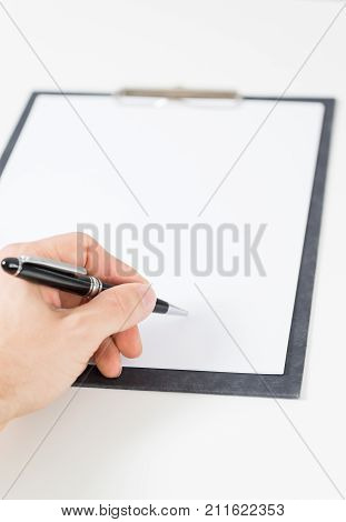white paper on clipboard on white background