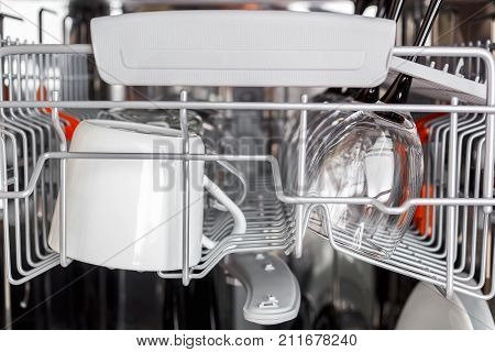 Open dishwasher with clean glass and dishes, selective focus, Clean glasses after washing in the dishwasher.