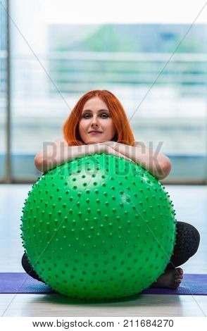 Woman working with swiss ball in the studio