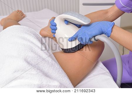 Beauty treatment of a young woman in specialized clinic. Body shaper