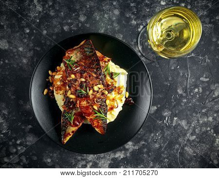 Sicilian style mackerel on cauliflower puree with caramelized onions, pine nuts served white wine.