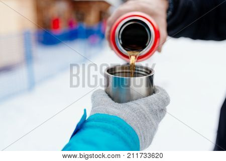Woman Pours Hot Tea Or Coffee From Metal Thermos