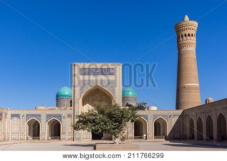 Courtyard at Po-i-Kalyan, with the madrasa and minaret - Bukhara, Uzbekistan. The complex include Kalyan four-iwan mosque and Kalyan minaret.