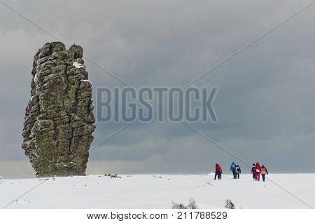 Tourists at the Manpupuner Plateau, Northern Ural. Giant Rocks. One of the seven wonders of Russia