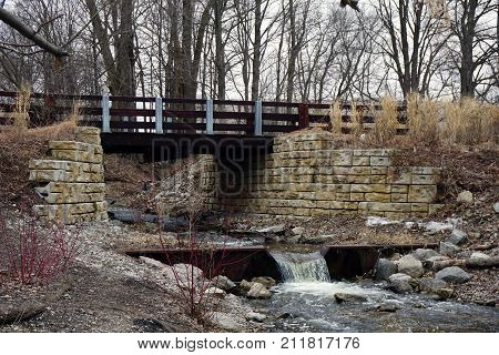 A bridge, along the Little Traverse Wheelway, which connects Charlevoix, Petoskey and Harbor Springs, Michigan, allows hikers and bicyclists to cross Tannery Creek.