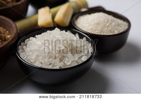 Jaggery, Sugar and cane - by-products of sugar cane or ganna like gur or jaggery, raw brown and refined white sugar, rock sugar crystals or mishri in Hindi. Selective focus