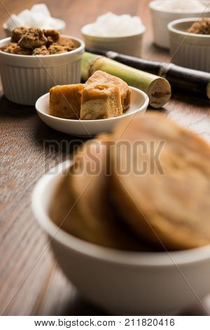 Jaggery, Sugar and cane - by-products of sugar cane or ganna like gur or jaggery, raw brown and refined white sugar, rock sugar crystals or mishri in Hindi. Selective focus