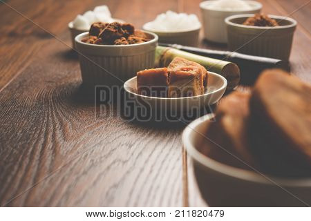 Jaggery, Sugar and cane - by-products of sugar cane or ganna like gur or jaggery, raw brown and refined white sugar, rock sugar crystals or mishri in Hindi. Selective focus