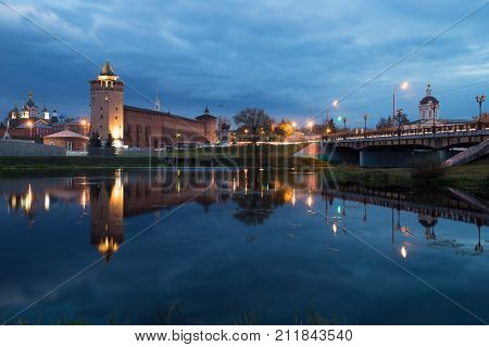Kolomna Moscow Region. Beautiful View: Assumption Brusensky Female Monastery Church Of Michael Archangel And Marinkin Tower Of Kremlin With Illumination By River On Blue Hour At Autumn Evening.