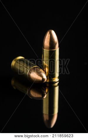 9mm pistol bullets on black table.