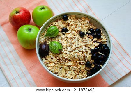 oatmeal with berries currants and gooseberries.muesli with apples and berries