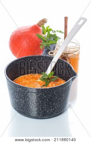 sweet pumpkin porridge with honey on a white background