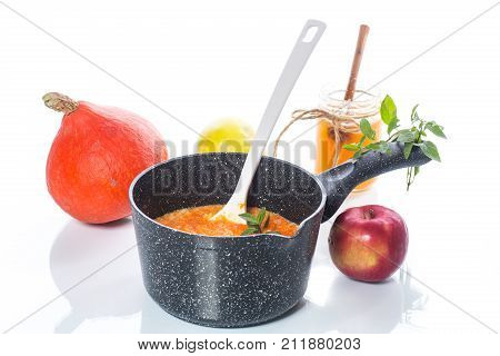 sweet pumpkin porridge with honey on a white background
